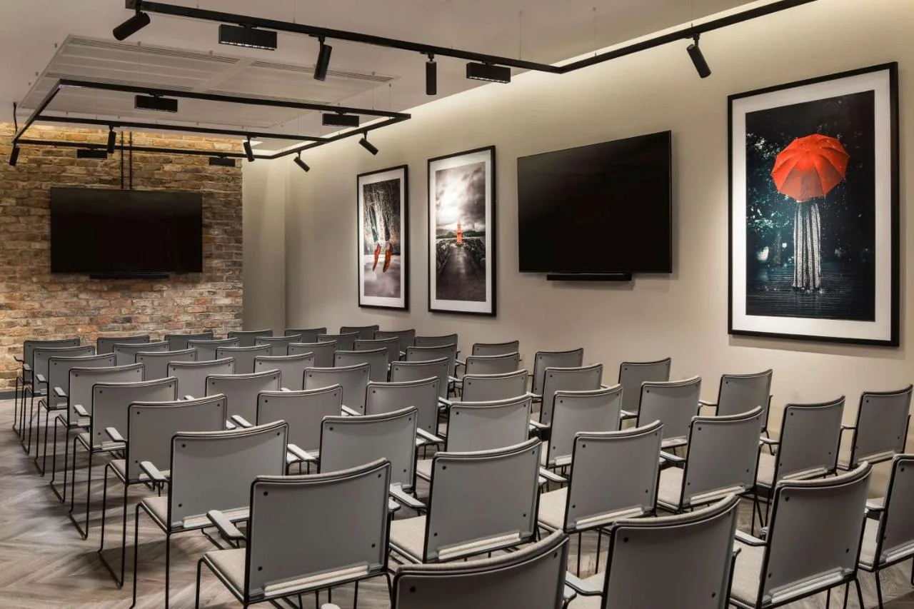a conference room with chairs and a flat screen tv at Radisson RED Hotel, Liverpool in Liverpool