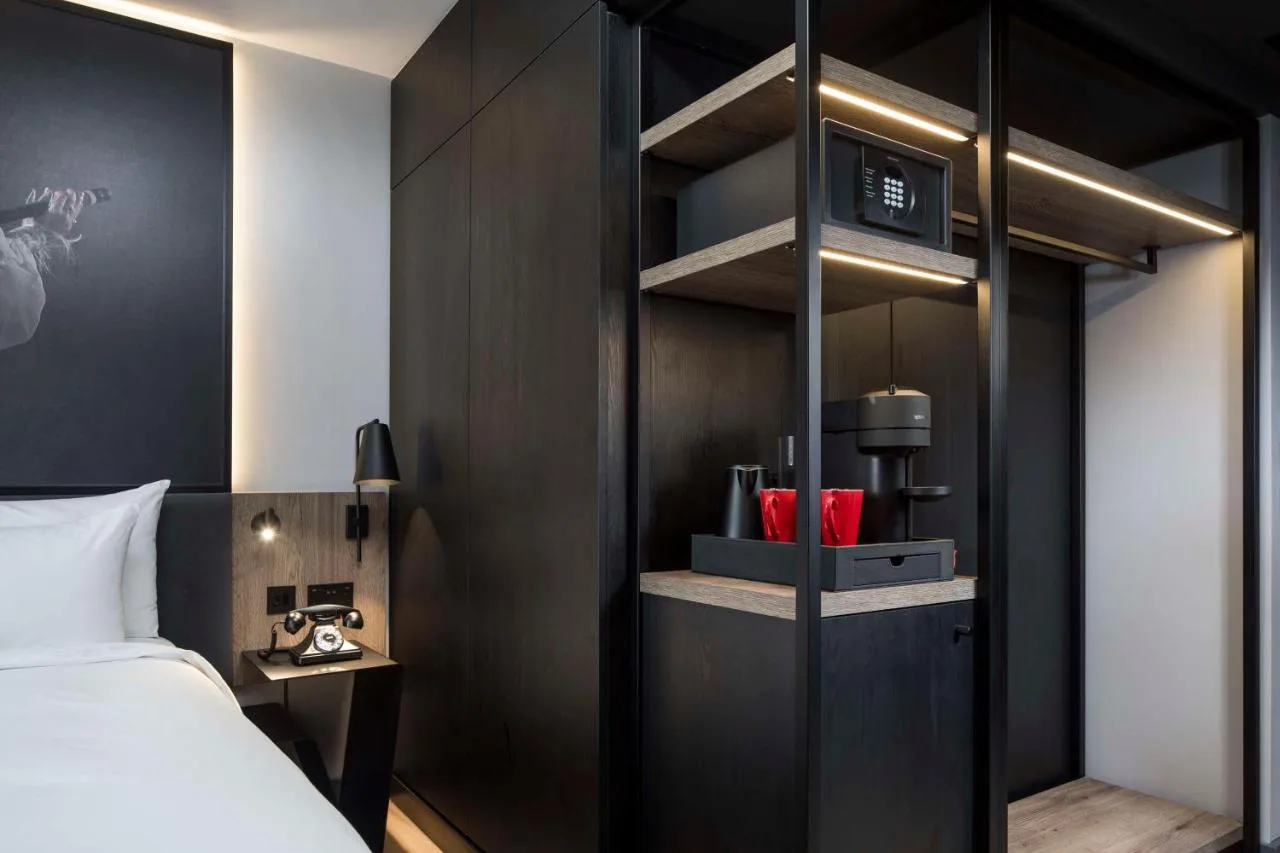a bedroom with a bed and a black wall at Radisson RED Hotel, Liverpool in Liverpool